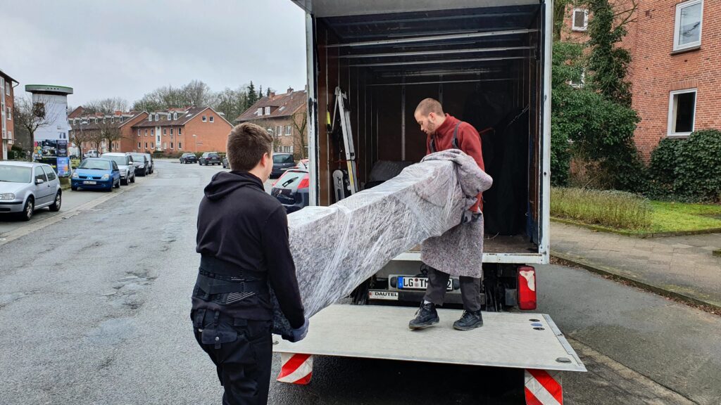 Mitarbeiter von Martens Umzüge beim Einladen eines Geschützen Möbelstückes in einen Transporter